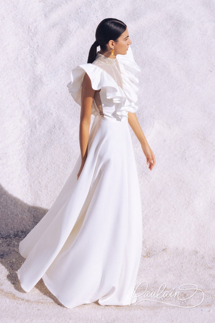 A white full-length dress with a high leg slit and rhinestone embellishments between the wing sleeves- JUPITER | Paulain